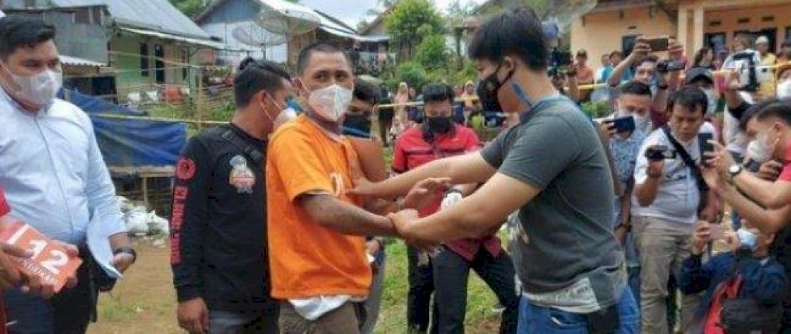 RD saat menjalani rekonstruksi kasus pembunuhan pemerkosa istrinya.