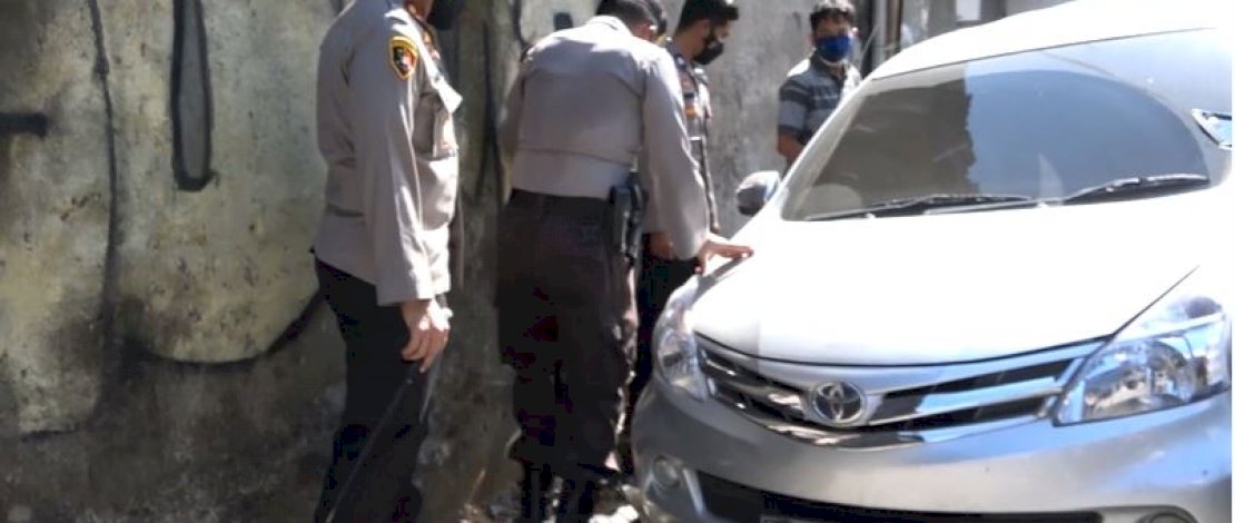 Kapolres Pelabuhana dan anggotanya mengevakuasi sebuah mobil yang terperosok ke dalam parit.