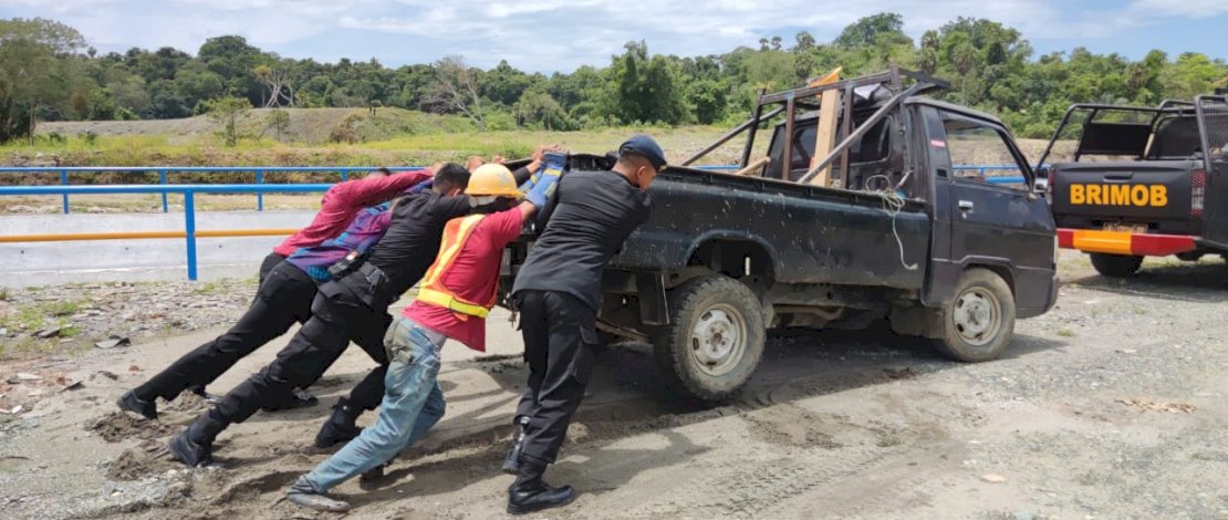 Danyon Brimob Bone Bantu Evakuasi Mobil Pickup Terjebak Lumpur