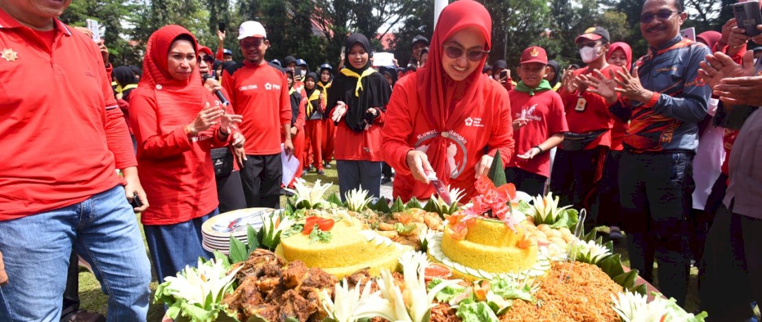 Bupati sekaligus Ketua PMI Luwu Utara, Indah Putri Indriani, memotong tumpeng pada peringatan HUT PMI ke 77, Sabtu, 17 September 2022.