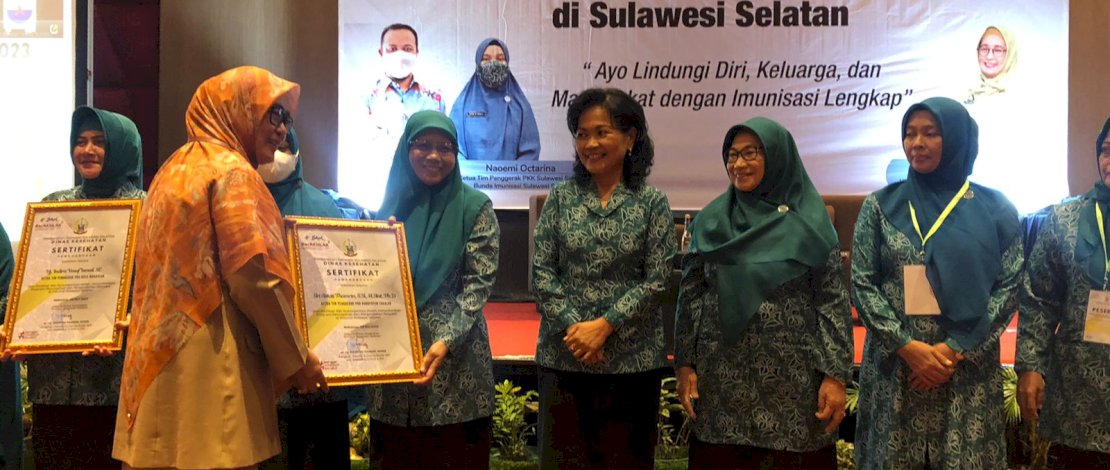 Pj Ketua TP PKK Takalar, Sri Astuti Thamrin, menerima penghargaan capaian imunisasi lengkap.